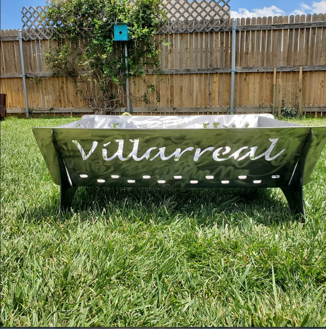 Actual fire pit with Villarreal name cut into metal